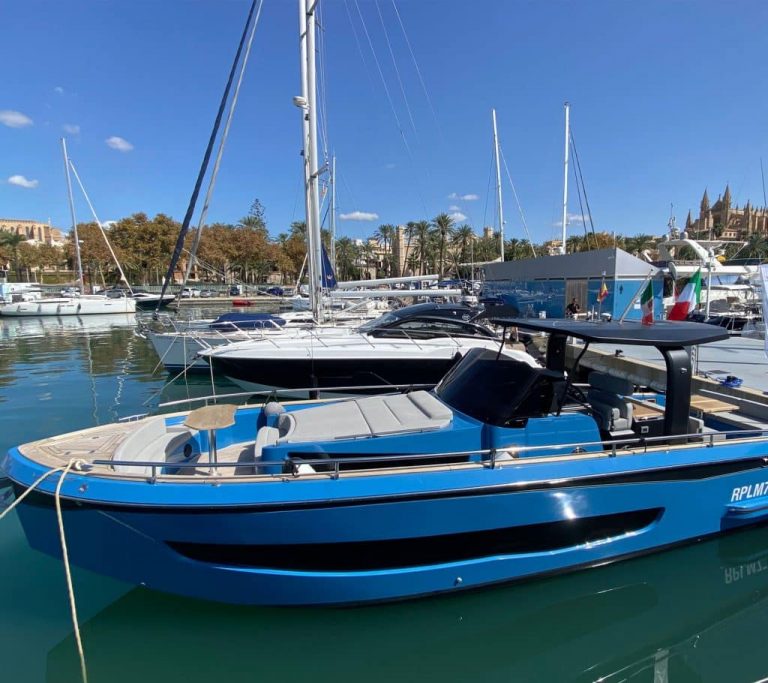 A blue motorboat docked in Port Vell for the Barcelona Boat Show 2023.