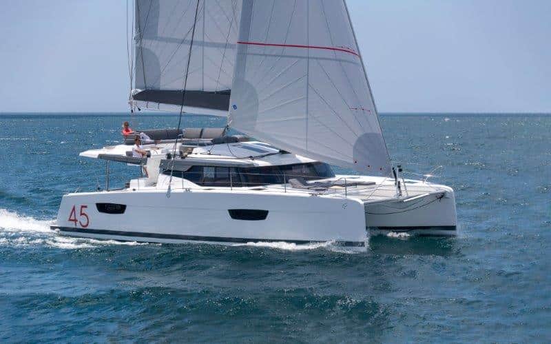 A white catamaran by Fountaine Pajot sailing in the sea.
